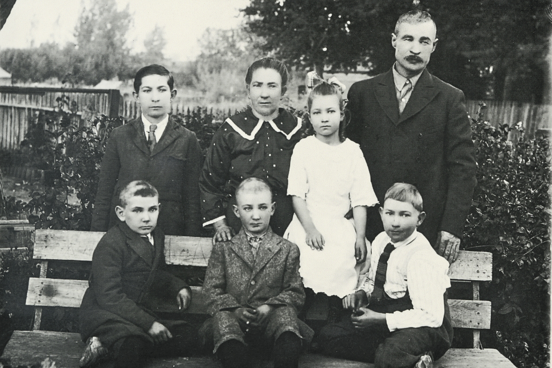 Harney Family, a woman and man with four children pose unsmiling