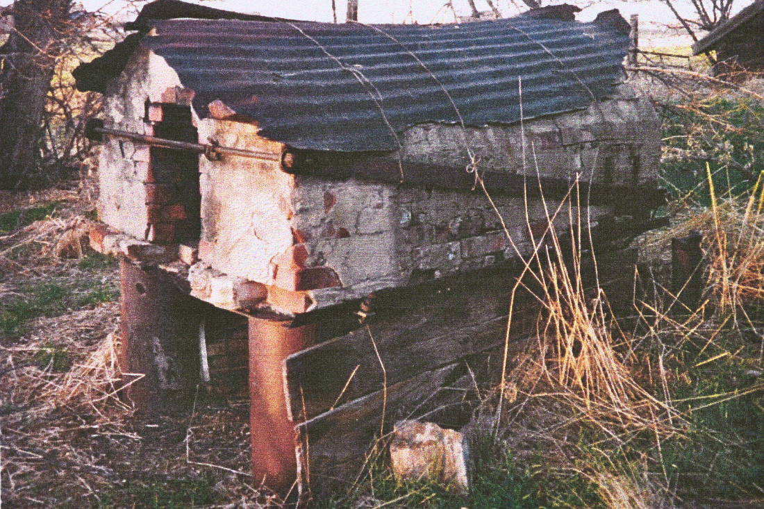 a dilapidated bread oven made of concrete and brick