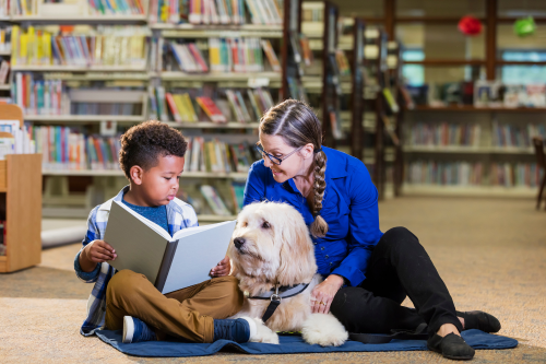 Rover: Child with Adult Reading to Service Dog