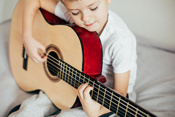boy playing a guitar