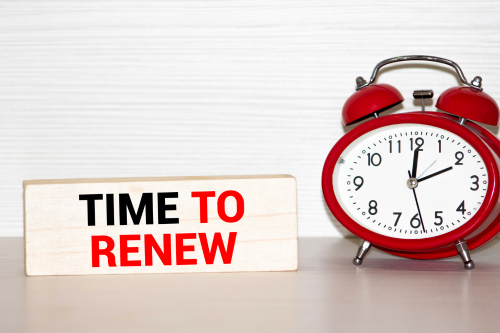 a red alarm clock sits next to the words "time to renew"