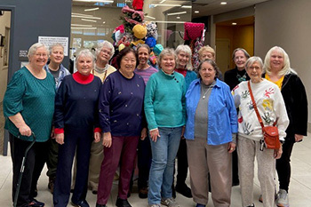 loving hands posing in front of tree of warmth