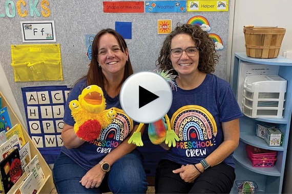 preschool teachers holding puppets with a play button
