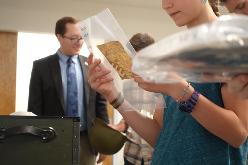 Photo of people examining artifacts at Vietnam War Traveling Trunk event