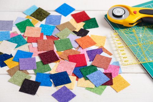 Crafting materials, fabric squares and rotary cutter