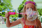 Little girl blowing bubbles