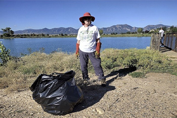 A volunteer picking up trash 
