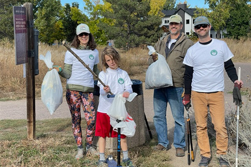 Volunteers picking up trash and clearing brush in a Louisville open space as part of the Adopt an Open Space program