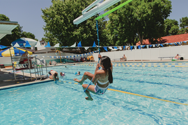 Little kid using the zip line at Memory Square Pool