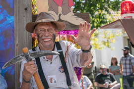 Man waving from Labor Day float
