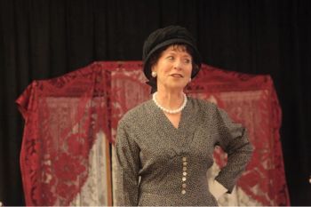 Actress dressed in costume and performing as author Anne Ellis.
