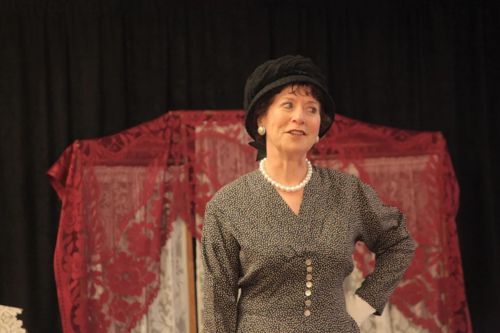 Historic reenactor dressed in costume and acting as author Anne Ellis.