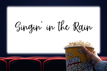 A person holding a bucket of popcorn in a movie theater, with "Singin' in the Rain" displayed on the blank screen.