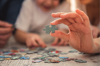 hand holding a puzzle piece