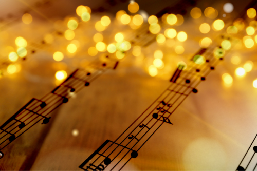 sheet music with holiday lights on top