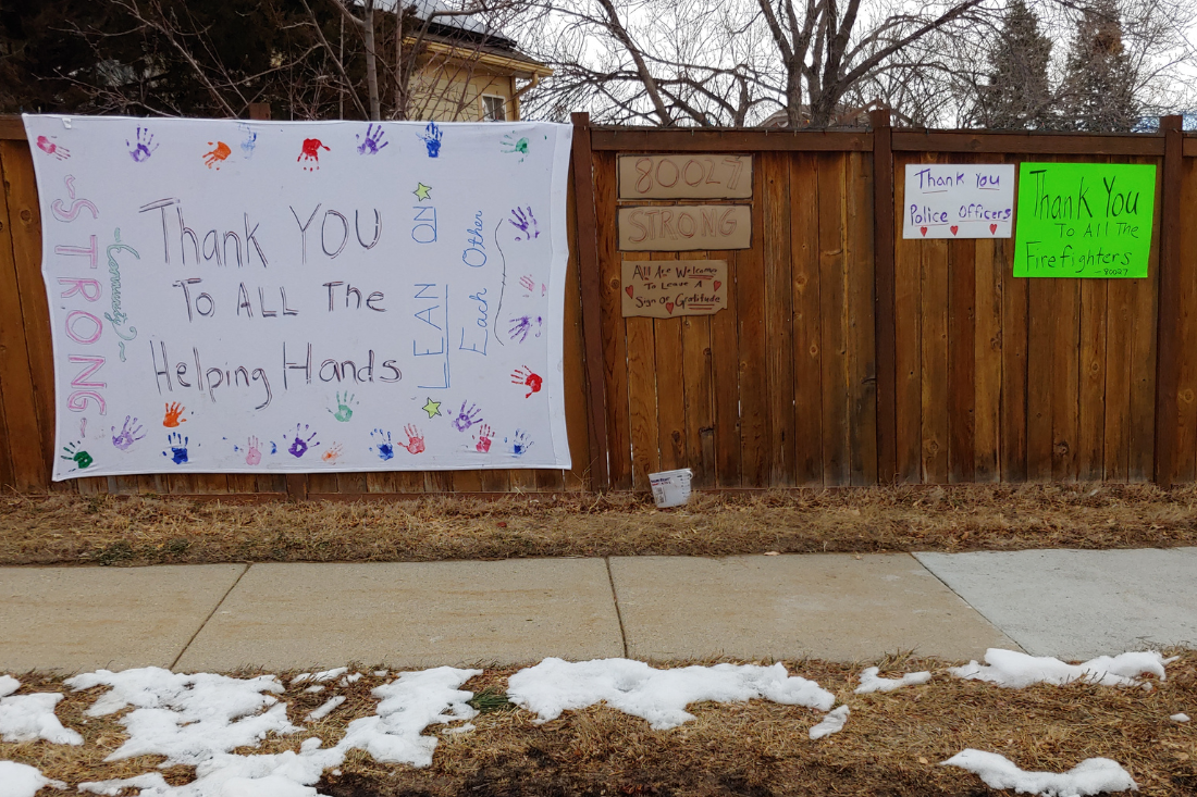 80027 Strong signs on fence after Marshall Fire