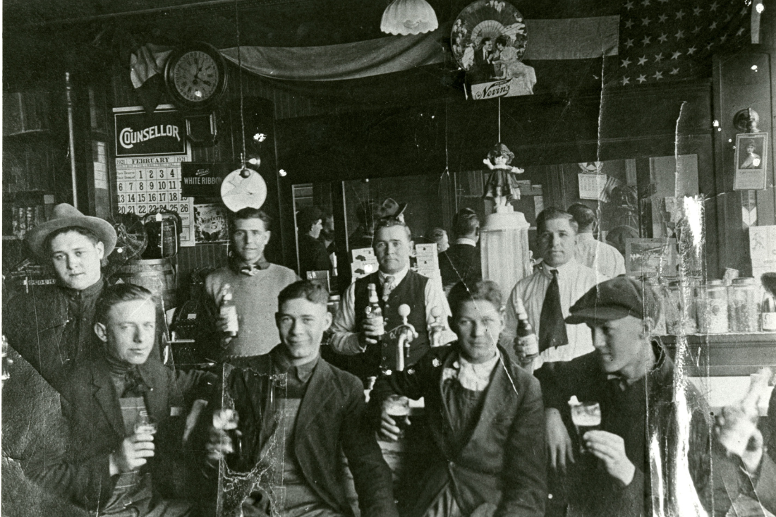 Eight men posing with beer inside of 809 Main St., Feb. 1921