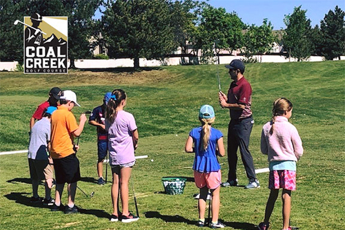 Children on golf course with instructor