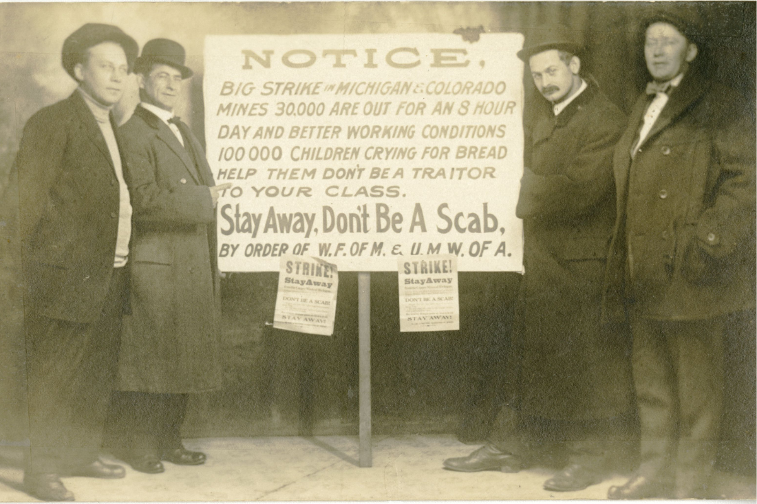 Tony Romeo poses with three union organizers with a strike sign, 1913.