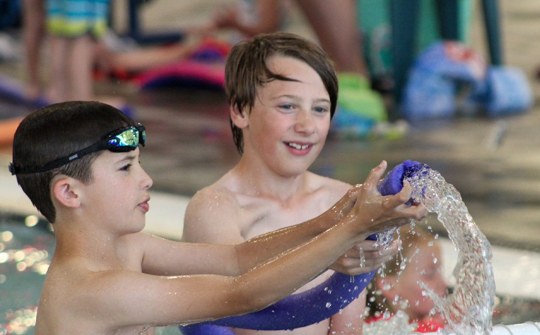 two kids swimming