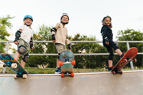 Three Kids Skateboarding