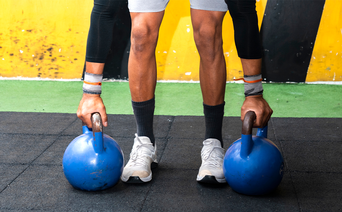 Guy picking up Kettlebells