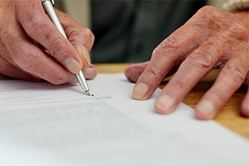 hand signing a legal document