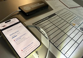 phone showing boco alert home page sitting on preparedness checklist
