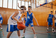 Kids playing team basketball