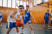 Kids playing team basketball