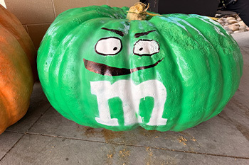 Pumpkin painted as a Green M&M