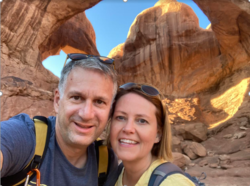 Caucasian Male and Female - middle aged - smiling in front of outdoor rock formations