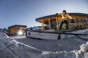 Snowboarder on rail at Rail Jam event
