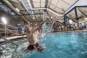 boy jumping in pool