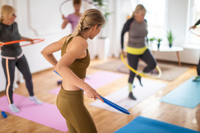 group of women hula hooping inside