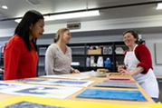 group of women learning how to use printing press
