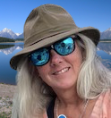 artist sharon speedy with lake and mountains in background