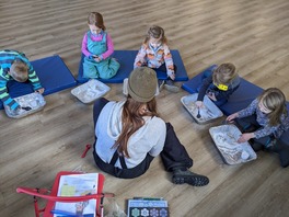 kids and instructor doing science experiment