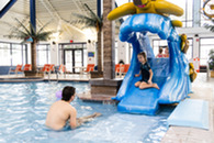 dad and daughter with kids turtle pool slide