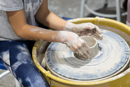 person at ceramics wheel
