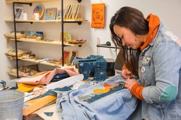 women sewing denim shirt