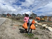 people cleaning up with trash bags