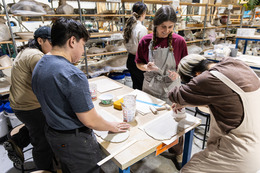 people hand sculpting with clay