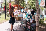 women shopping at a local art vendor at an art stroll