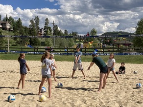 youth playing beach volleyball
