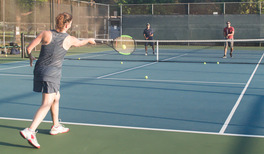 adults playing tennis