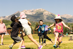 kids playing outside with mountain in background