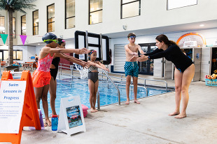 group of kids and instructor at swim lessons