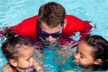 instructor teaches swim class