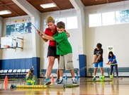 TGA staff teaching a junior golfer